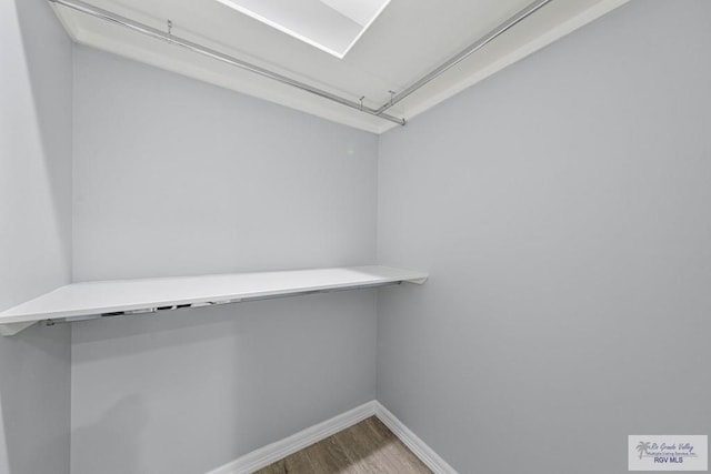 walk in closet featuring hardwood / wood-style flooring