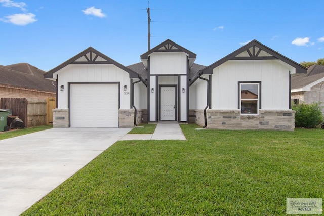 view of front of home with a garage and a front lawn