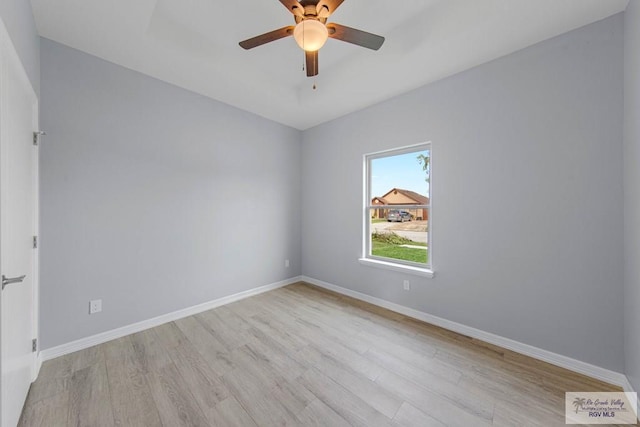 empty room featuring ceiling fan and light hardwood / wood-style flooring