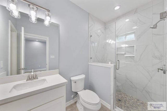 bathroom featuring vanity, toilet, and walk in shower