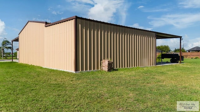 view of property exterior featuring a lawn and an outbuilding