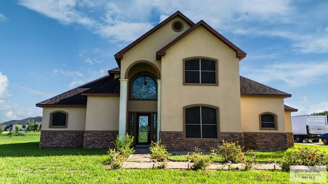 rear view of house featuring a lawn