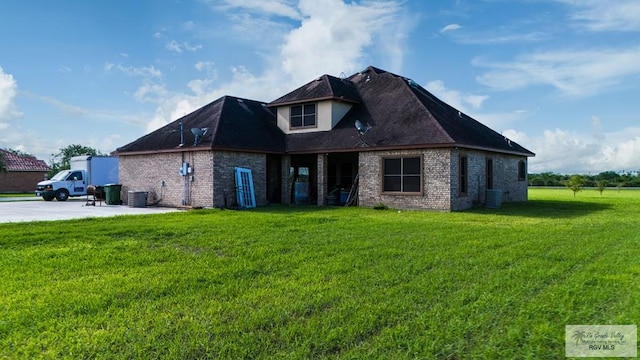exterior space with a yard and central AC