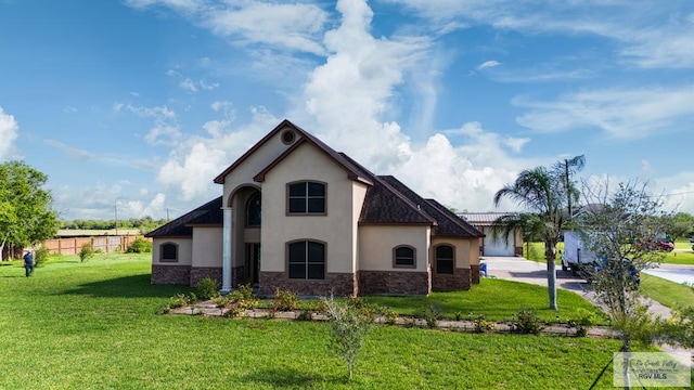 back of house with a lawn