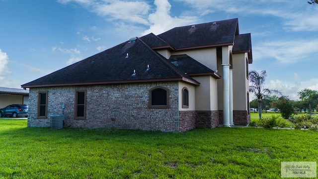 view of side of home featuring a yard and cooling unit