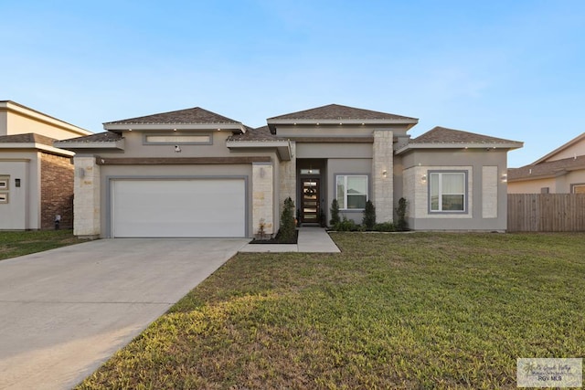 prairie-style home featuring a garage and a front yard