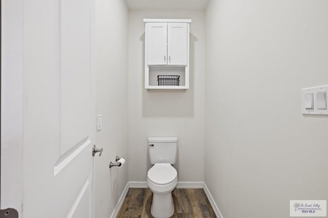 bathroom with hardwood / wood-style floors and toilet