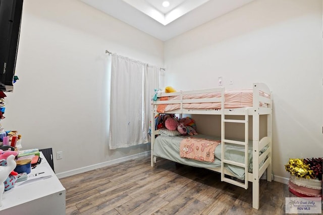 bedroom with hardwood / wood-style flooring