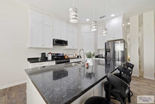 kitchen with pendant lighting, sink, an island with sink, white cabinetry, and stainless steel appliances