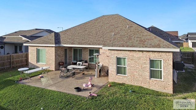 back of property featuring central air condition unit, a patio area, and a yard