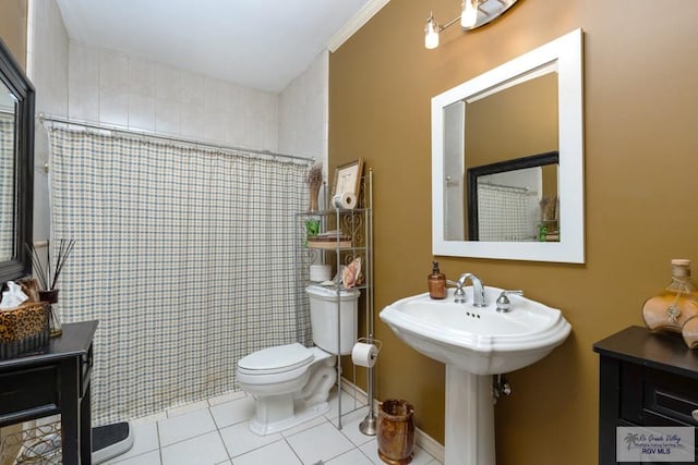 bathroom featuring toilet, curtained shower, and tile patterned flooring