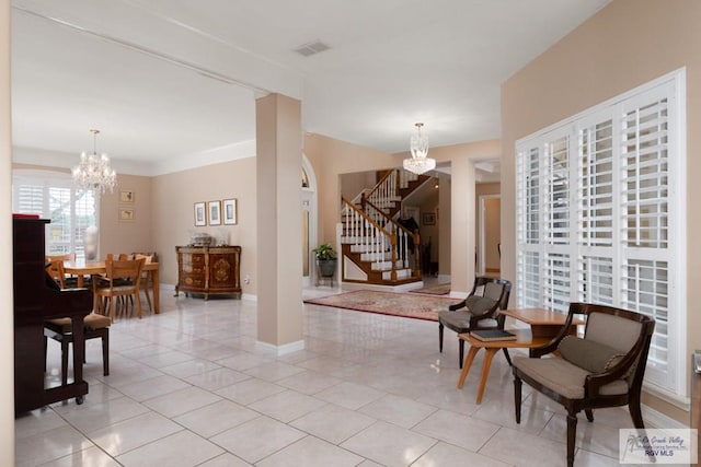 interior space featuring crown molding and a notable chandelier