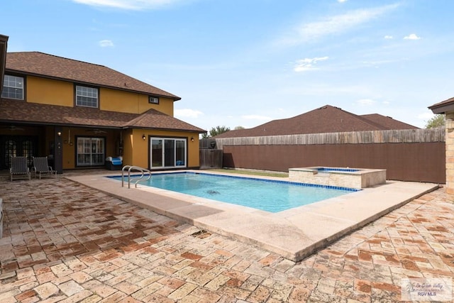 view of swimming pool with a patio and an in ground hot tub