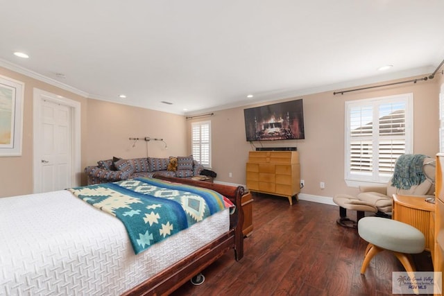 bedroom with crown molding and dark hardwood / wood-style floors