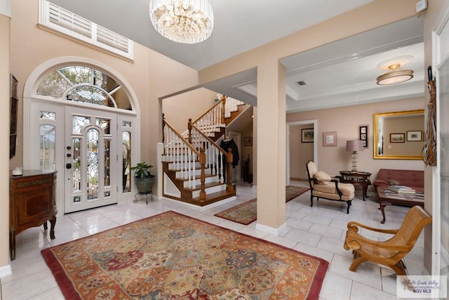 entryway with a notable chandelier and light tile patterned flooring