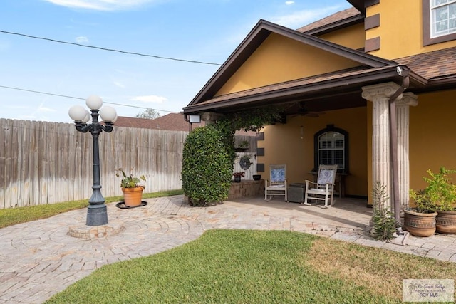 view of yard featuring a patio area and ceiling fan