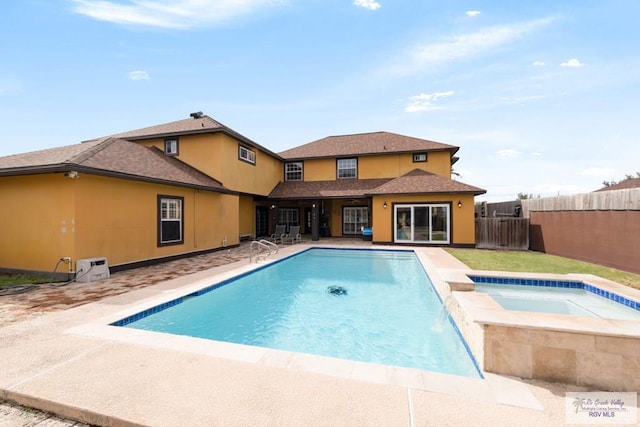 view of swimming pool featuring an in ground hot tub and a patio area