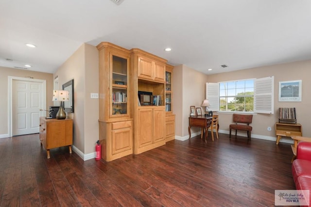 sitting room with dark wood-type flooring