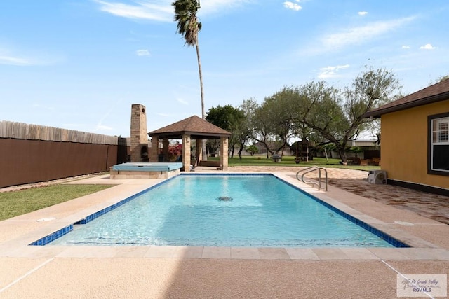 view of swimming pool featuring a gazebo, an in ground hot tub, and a patio area