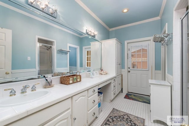 bathroom with tile patterned flooring, vanity, ornamental molding, and walk in shower