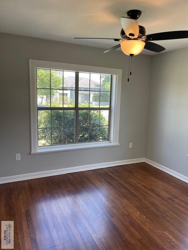 empty room featuring dark hardwood / wood-style flooring, plenty of natural light, and ceiling fan