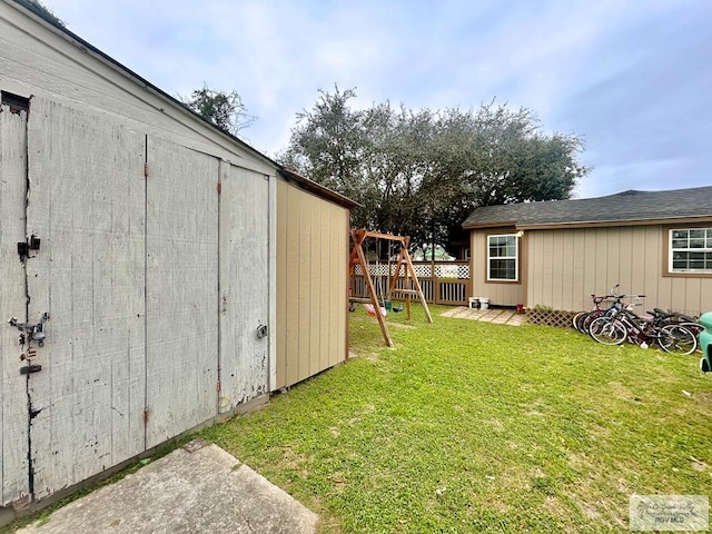 view of yard featuring a playground and fence