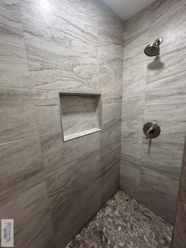 full bath featuring tiled shower