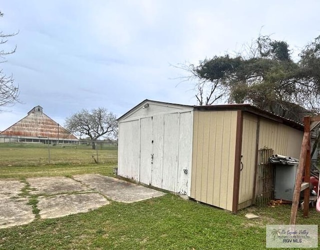 view of shed featuring fence