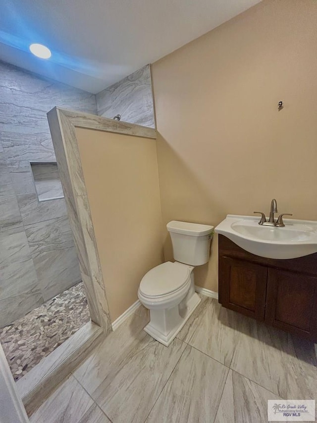 full bath with toilet, baseboards, walk in shower, and vanity