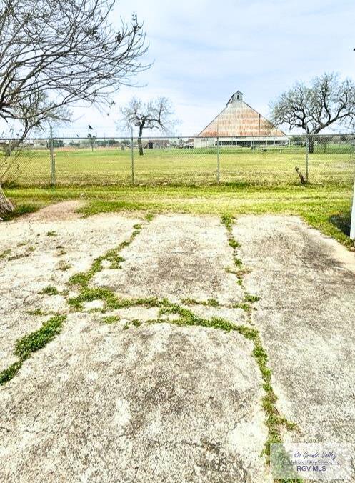 view of yard with a rural view and fence