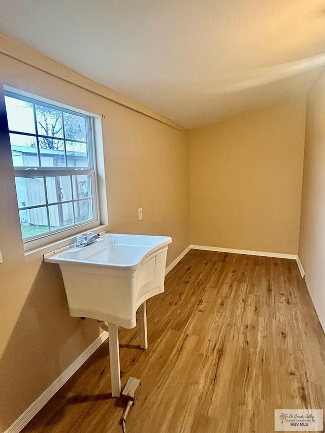 recreation room featuring baseboards and light wood-style floors