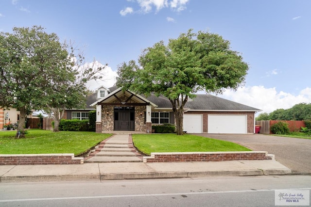 5363 Rustic Manor Dr, Brownsville, TX 78526 - view of front of house featuring asphalt driveway, a garage, and brick siding