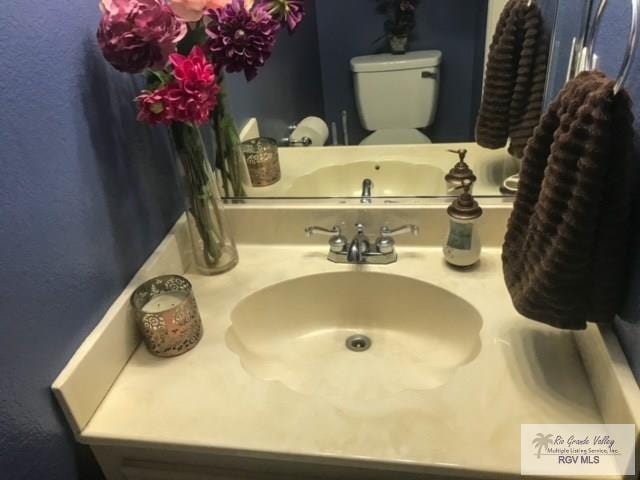 bathroom featuring vanity and toilet