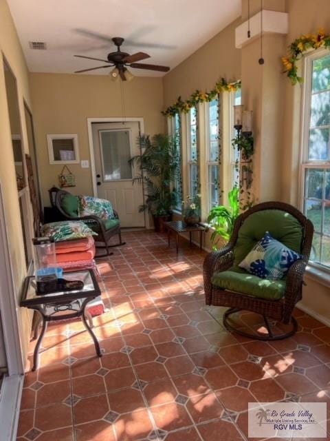 sunroom / solarium featuring a wealth of natural light and ceiling fan