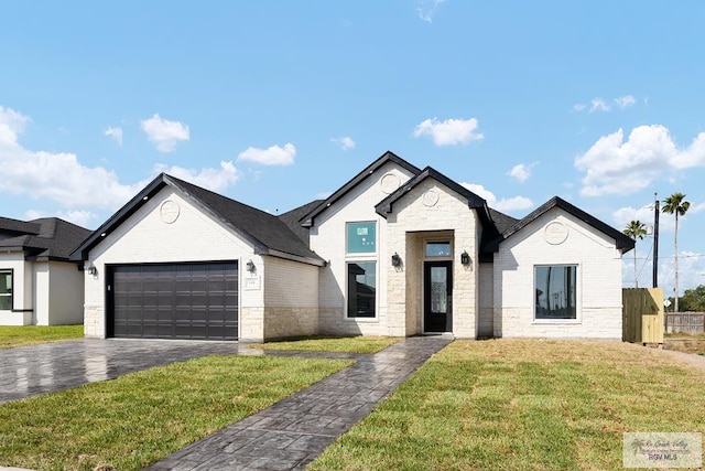 view of front facade with a front yard and a garage