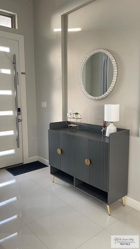 bathroom with baseboards and tile patterned floors