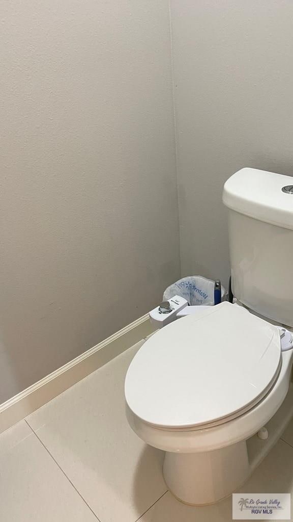 bathroom with toilet and tile patterned floors