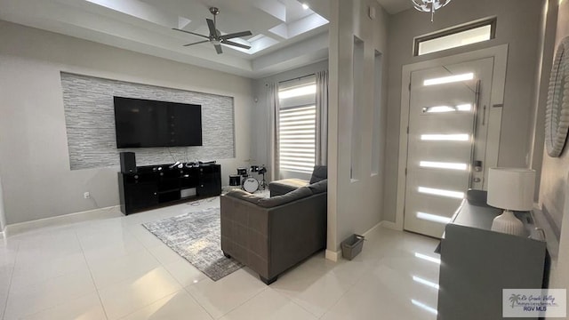 living room featuring light tile patterned floors, ceiling fan, and baseboards