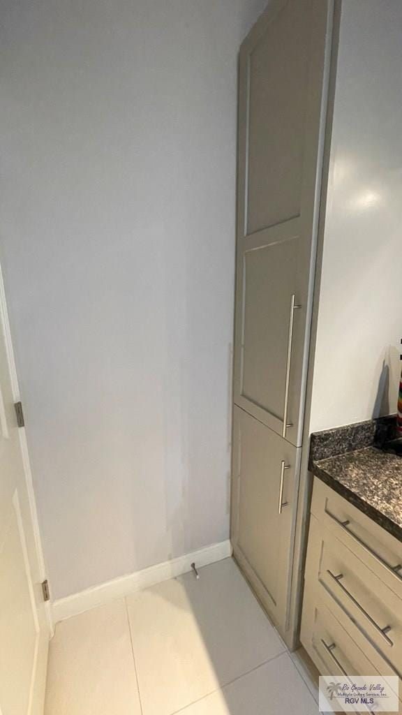 bathroom with baseboards and tile patterned floors