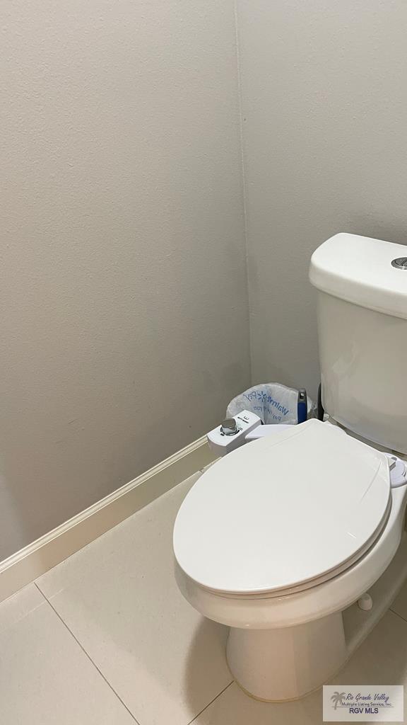 bathroom with toilet and tile patterned flooring