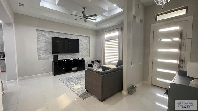 living room with visible vents, light tile patterned flooring, a ceiling fan, and baseboards