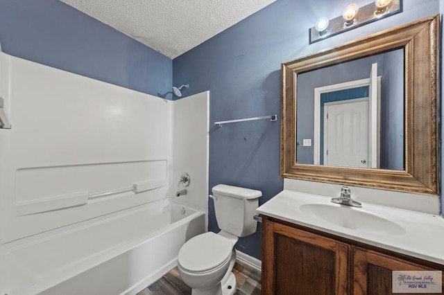 1013 Champlain Dr, Brownsville, TX 78526 - bathroom featuring vanity, a textured ceiling, shower / bathtub combination, and wood finished floors