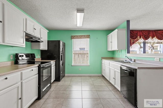 1013 Champlain Dr, Brownsville, TX 78526 - kitchen with black appliances, under cabinet range hood, white cabinetry, and a textured ceiling