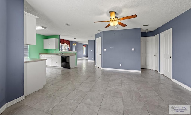 1013 Champlain Dr, Brownsville, TX 78526 - unfurnished living room with a textured ceiling and a ceiling fan