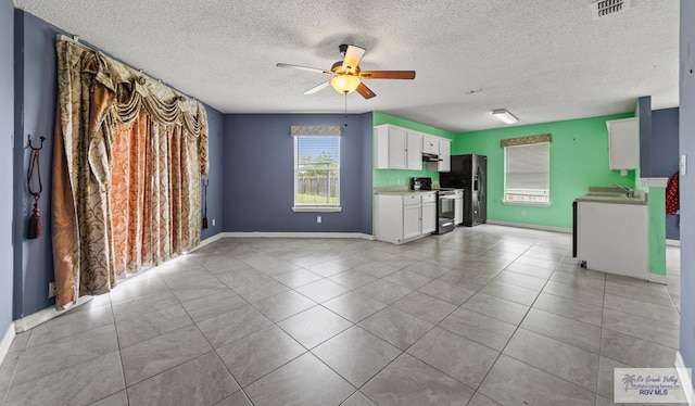 1013 Champlain Dr, Brownsville, TX 78526 - unfurnished living room with a ceiling fan, a textured ceiling, and light tile patterned flooring