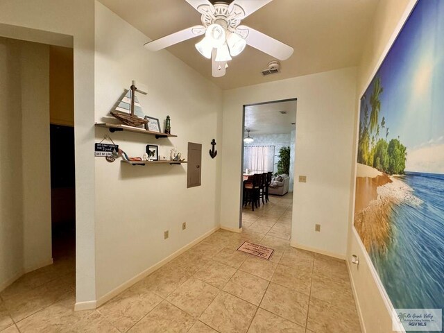 hallway with electric panel and light tile patterned floors