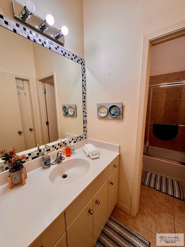 bathroom featuring vanity, tile patterned floors, and an enclosed shower