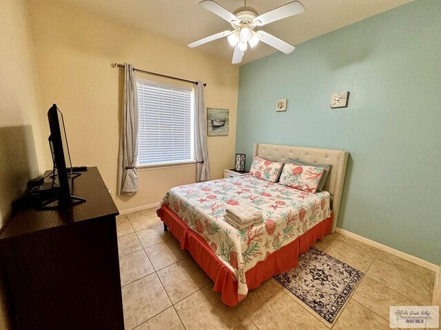 tiled bedroom with ceiling fan