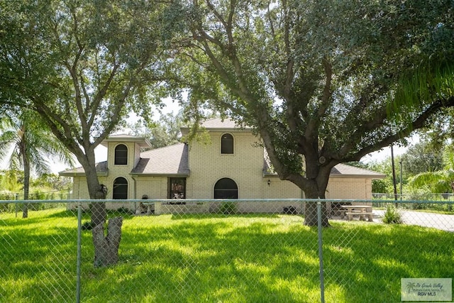 mediterranean / spanish home with a front lawn