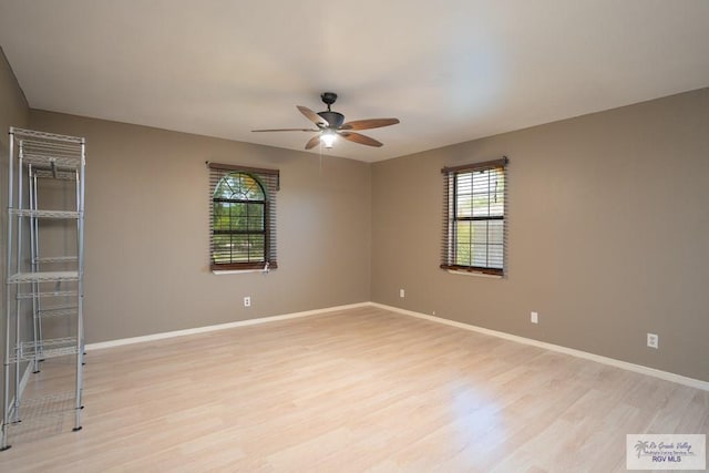 unfurnished room with ceiling fan and light wood-type flooring